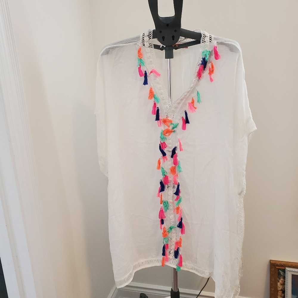 white Finovas tunic features colorful tassels and embroidere